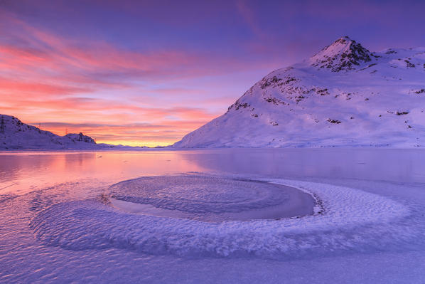 Frost has created a strange form of ice in the middle of Lake Bianco at Bernina Pass. Canton of Graubunden. Engadine. Switzerland. Europe