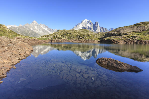 The Mont Blanc mountain range reflected in the waters of Lac de Chesery. Haute Savoie France Europe