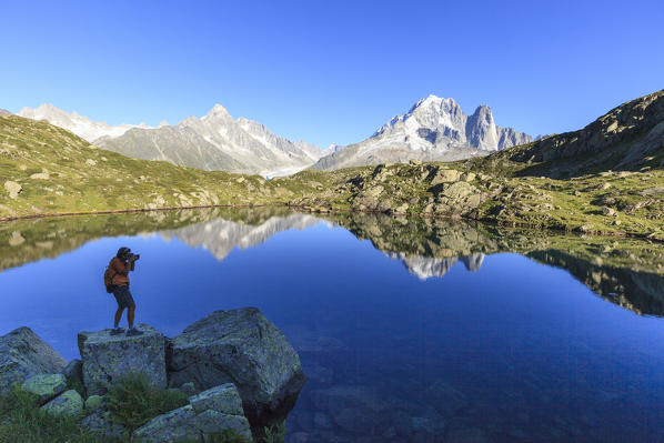 Photographer in the scenery of Lac de Cheserys. Haute Savoie. France Europe