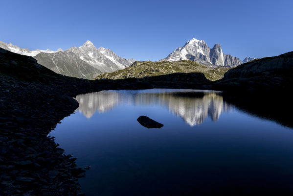 The Mont Blanc mountain range reflected in the waters of Lac de Chesery. Haute Savoie France