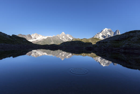 The Mont Blanc mountain range reflected in the waters of Lac de Chesery. Haute Savoie France