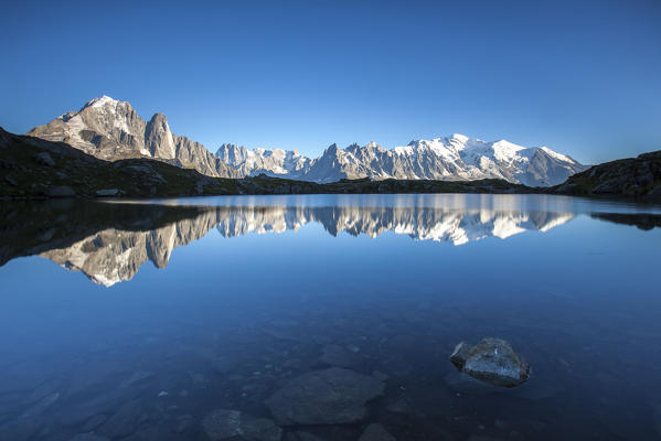 The Mont Blanc mountain range reflected in the waters of Lac de Chesery. Haute Savoie France Europe