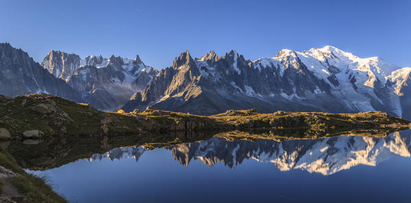 The Mont Blanc mountain range reflected in the waters of Lac de Chesery at sunrise. Haute Savoie France Europe
