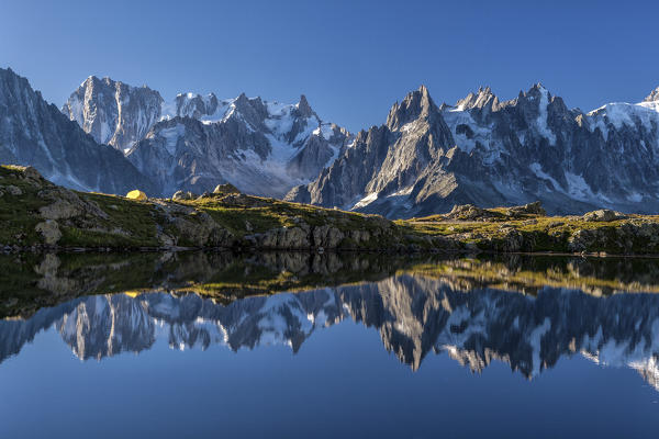 The Mont Blanc mountain range reflected in the waters of Lac de Chesery at sunrise. Haute Savoie France Europe