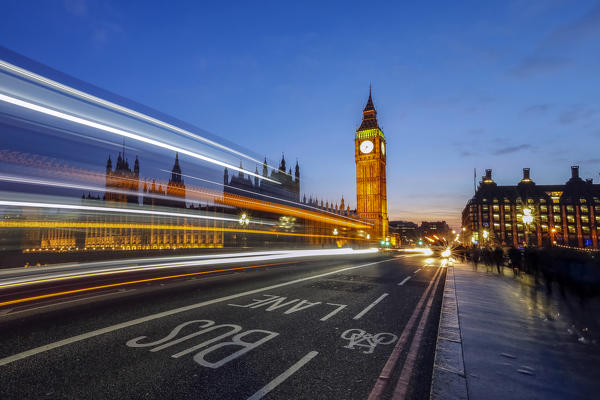 Doubledeckerbus runs towards Big Ben also called Elizabeth Tower, located north end of the Palace of Westminster in London United Kingdom Europe