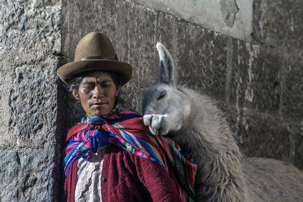 Andean woman in typical dresses with his Llama in Cusco centre, Peru South America