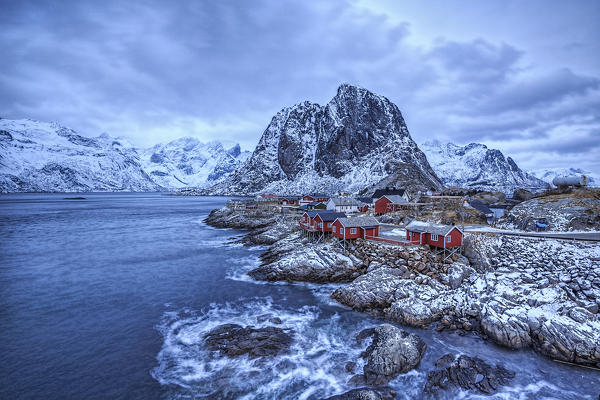 Dusk lights on the typical red houses and the rough sea Hamnøy Lofoten Islands Northern Norway Europe