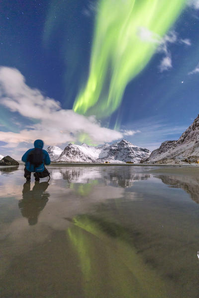 Photographer admire the colors of the Northern Lights. Skagsanden. Lofoten Islands. Norway. Europe