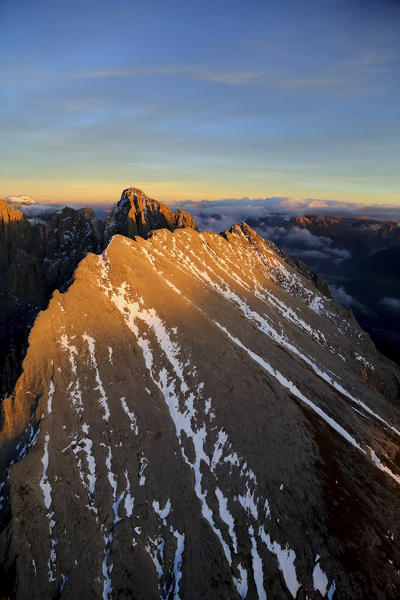 Aerial shot of Sassolungo at sunset. Sella Group Val Gardena. Dolomites Trentino Alto Adige Italy Europe