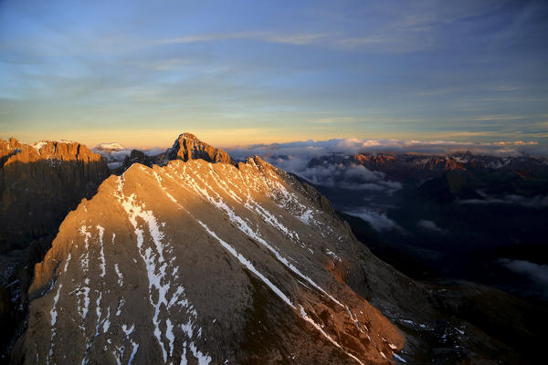 Aerial shot of Sassolungo at sunset. Sella Group Val Gardena. Dolomites Trentino Alto Adige Italy Europe