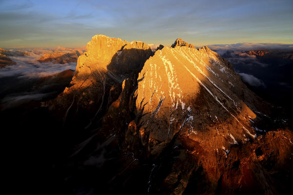 Aerial shot of Sassolungo and Sassopiatto at sunset. Sella Group Val Gardena. Dolomites Trentino Alto Adige Italy Europe