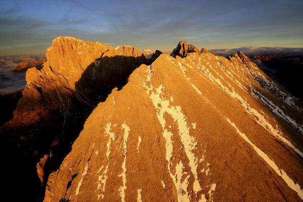 Aerial shot of Sassolungo and Sassopiatto at sunset. Sella Group Val Gardena. Dolomites Trentino Alto Adige Italy Europe