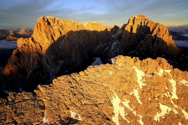 Aerial viiew of Sassolungo and Sassopiatto at sunset. Sella Group Val Gardena. Dolomites Trentino Alto Adige Italy Europe