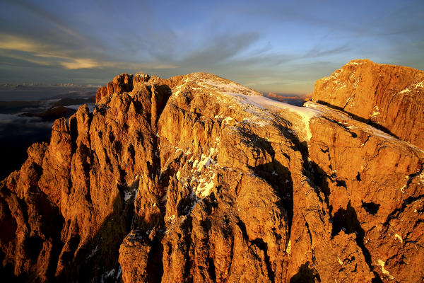 Aerial shot of Sassolungo and Sassopiatto at sunset. Sella Group Val Gardena. Dolomites Trentino Alto Adige Italy Europe