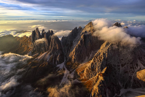 Aerial view of the mountain range of Odle surrounded by clouds. Dolomites Funes Valley Trentino Alto Adige South Tyrol Italy Europe