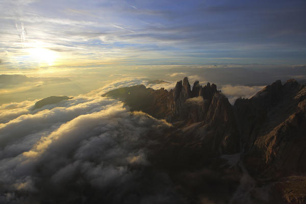 Aerial view of the mountain range of Odle surrounded by clouds. Dolomites Val Funes Trentino Alto Adige South Tyrol Italy Europe