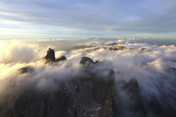 Aerial view of the mountain range of Odle surrounded by clouds. Dolomites Val Funes Trentino Alto Adige South Tyrol Italy Europe