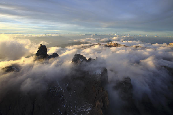 Aerial view of the mountain range of Odle surrounded by clouds. Dolomites Val Funes Trentino Alto Adige South Tyrol Italy Europe