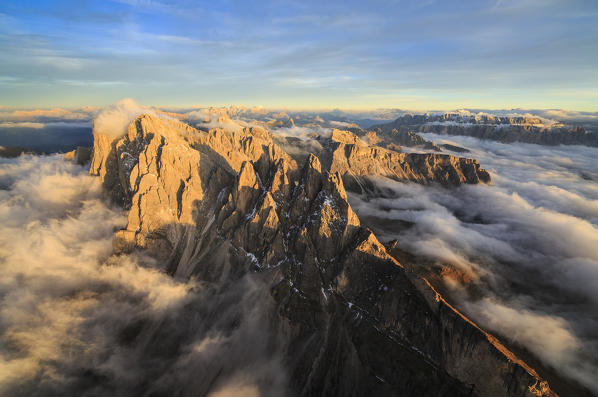 Aerial view of the mountain range of Odle surrounded by clouds. Dolomites Val Funes Trentino Alto Adige South Tyrol Italy Europe
