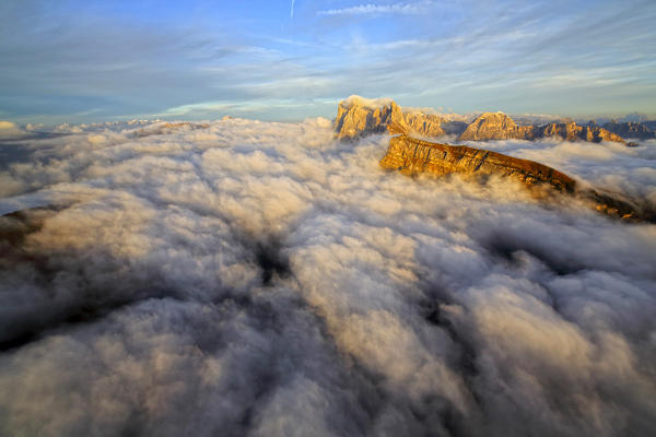 Aerial shot from Seceda of Odle surrounded by clouds at sunset. Dolomites Val Funes Trentino Alto Adige South Tyrol Italy Europe
