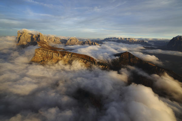 Aerial view from Seceda of Odle surrounded by clouds at sunset. Dolomites Val Funes Trentino Alto Adige South Tyrol Italy Europe