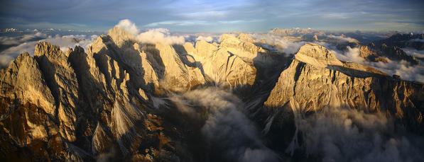 Aerial view of the mountain range of Odle surrounded by clouds. Dolomites Val Funes Trentino Alto Adige South Tyrol Italy Europe