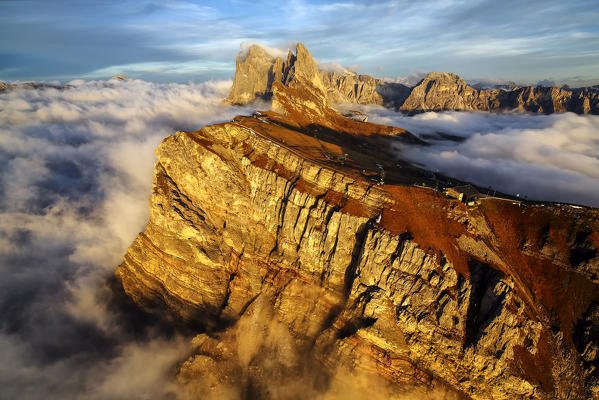 Aerial view of the mountain range of Odle dolomites surrounded by the clouds. Dolomites, Funes Valley, Trentino-Alto Adige, South Tyrol, Italy.