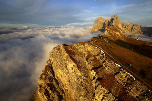 Aerial shot from Seceda of Odle surrounded by clouds at sunset. Dolomites Val Funes Trentino Alto Adige South Tyrol Italy Europe