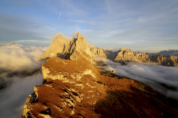 Aerial view from Seceda of Odle surrounded by clouds at sunset. Dolomites Val Funes Trentino Alto Adige South Tyrol Italy Europe