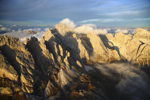 Aerial view of the mountain range of Odle surrounded by clouds. Dolomites Val Funes Trentino Alto Adige South Tyrol Italy Europe