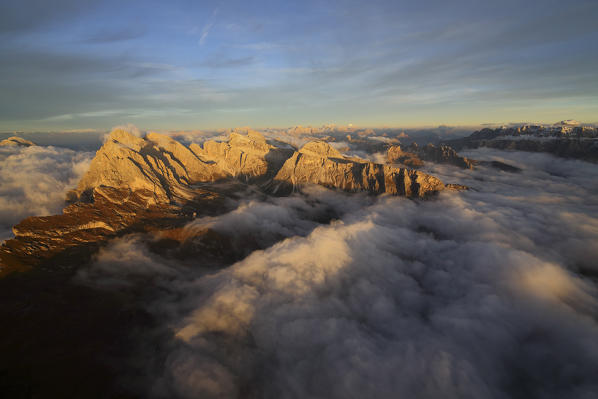 Aerial shot from Seceda of Odle surrounded by clouds at sunset. Dolomites Val Funes Trentino Alto Adige South Tyrol Italy Europe