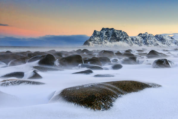 The cold wind that blows constantly shapes the snow on the rocks around Uttakleiv at dawn. Lofoten Islands Norway Europe