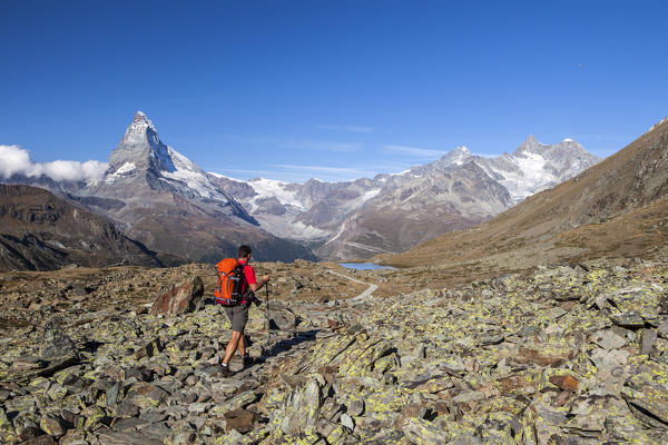 Hiker proceeds towards the Matterhorn. Zermatt Canton of Valais Pennine Alps Switzerland Europe