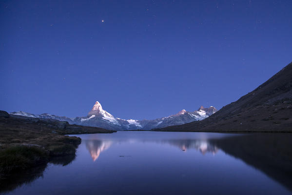 The Matterhorn reflected in Stellisee at sunrise. Zermatt Canton of Valais Pennine Alps Switzerland Europe