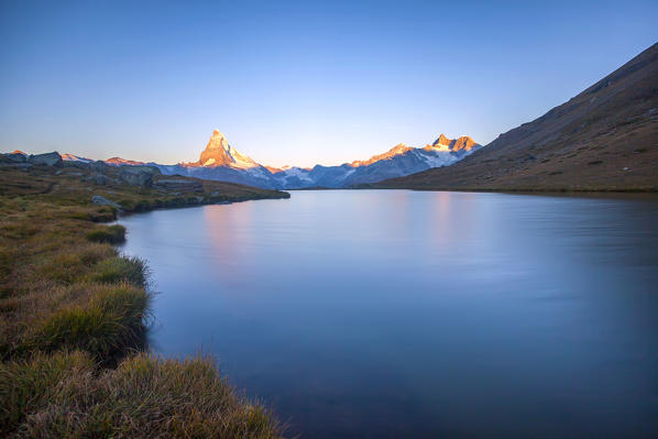 Dawn light up the Matterhorn seen from Stellisee. Zermatt Canton of Valais Pennine Alps Switzerland Europe