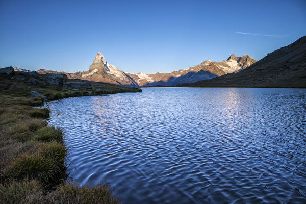 Dawn light up the Matterhorn seen from Stellisee. Zermatt Canton of Valais Pennine Alps Switzerland Europe