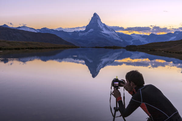 The photographer captures the Matterhorn at sunrise from Stellisee. Zermatt Canton of Valais Pennine Alps Switzerland Europe