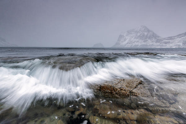 Waves crashing on the rocks of the cold sea. Haukland. Lofoten Islands Northern Norway Europe