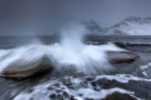 Waves crashing on the rocks of the cold sea. Haukland. Lofoten Islands Northern Norway Europe