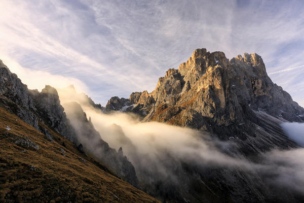 Low clouds and dawn lights on the peaks of Forcella De Furcia. Funes Valley South Tyrol Dolomites Italy Europe
