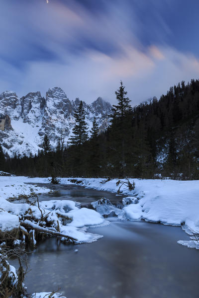 A frozen creek under a cold winter sky. Venagia Valley Panaveggio Natural Park Dolomites Trentino Alto Adige Italy Europe