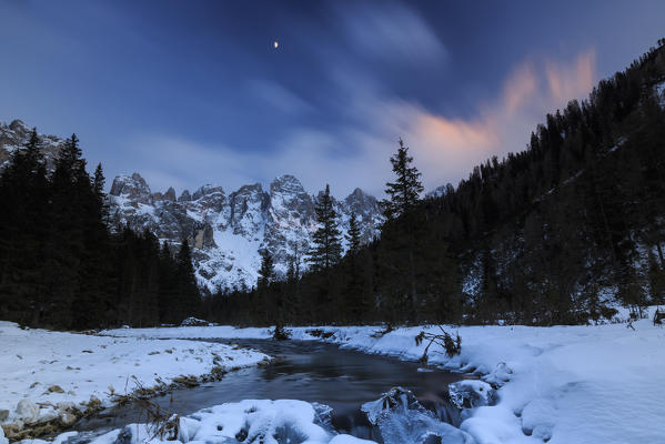 A frozen creek under a cold winter sky. Venagia Valley Panaveggio Natural Park Dolomites Trentino Alto Adige Italy Europe