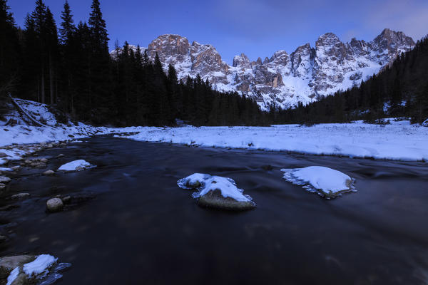 A frozen creek under a cold winter sky. Venagia Valley Panaveggio Natural Park Dolomites Trentino Alto Adige Italy Europe