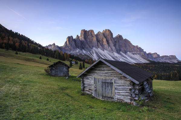 The early morning light illuminates Malga Zannes and the Odle in background. Funes Valley South Tyrol Dolomites Italy Europe