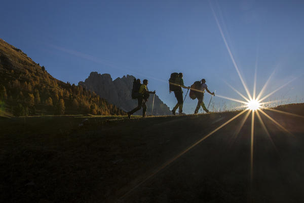 Hikers  proceed from  Malga Gampen. Funes Valley South Tyrol Dolomites Italy Europe