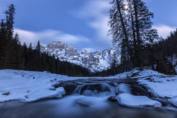 A frozen creek under a cold winter sky. Venagia Valley Panaveggio Natural Park Dolomites Trentino Alto Adige Italy Europe