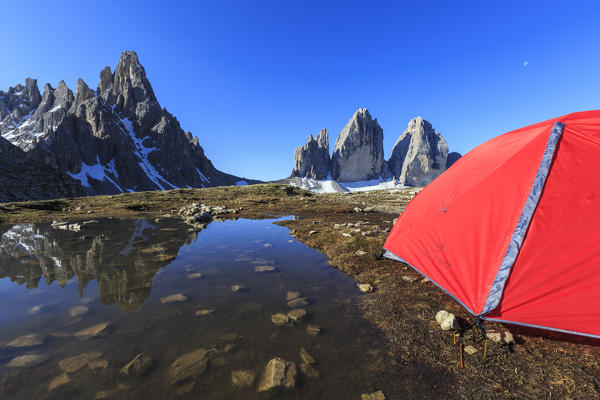 Hikers tent in front of the Three Peaks of Lavaredo at sunsirse. Sesto Dolomites Trentino Alto Adige Italy Europe