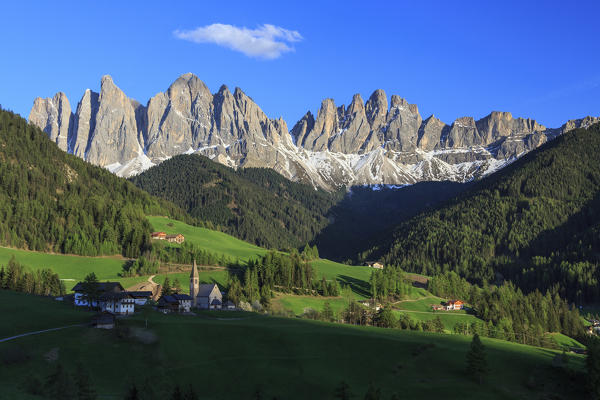 The village of St. Magdalene surrounded by green meadows at the foot of the Odle Funes Valley South Tyrol Dolomites Italy Europe