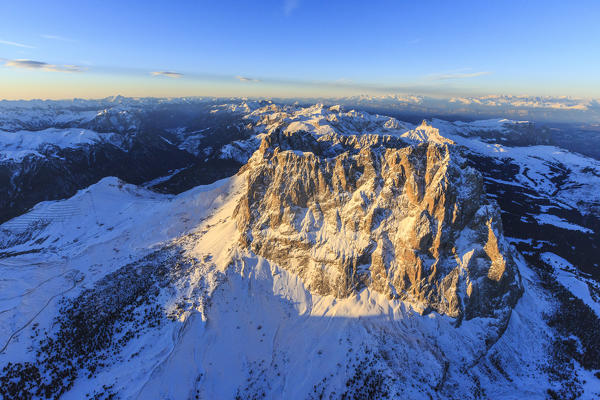 Aerial view of Sassolungo Sassopiatto and Grohmann peak at sunset. Dolomites Sella Group Trentino Alto Adige Italy Europe