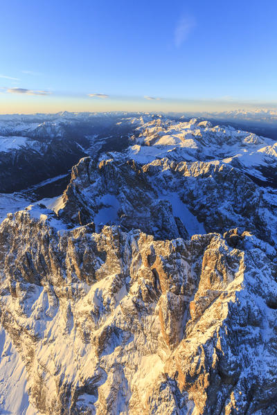 Aerial view of Sassolungo Sassopiatto and Grohmann peak at sunset. Dolomites Sella Group Trentino Alto Adige Italy Europe